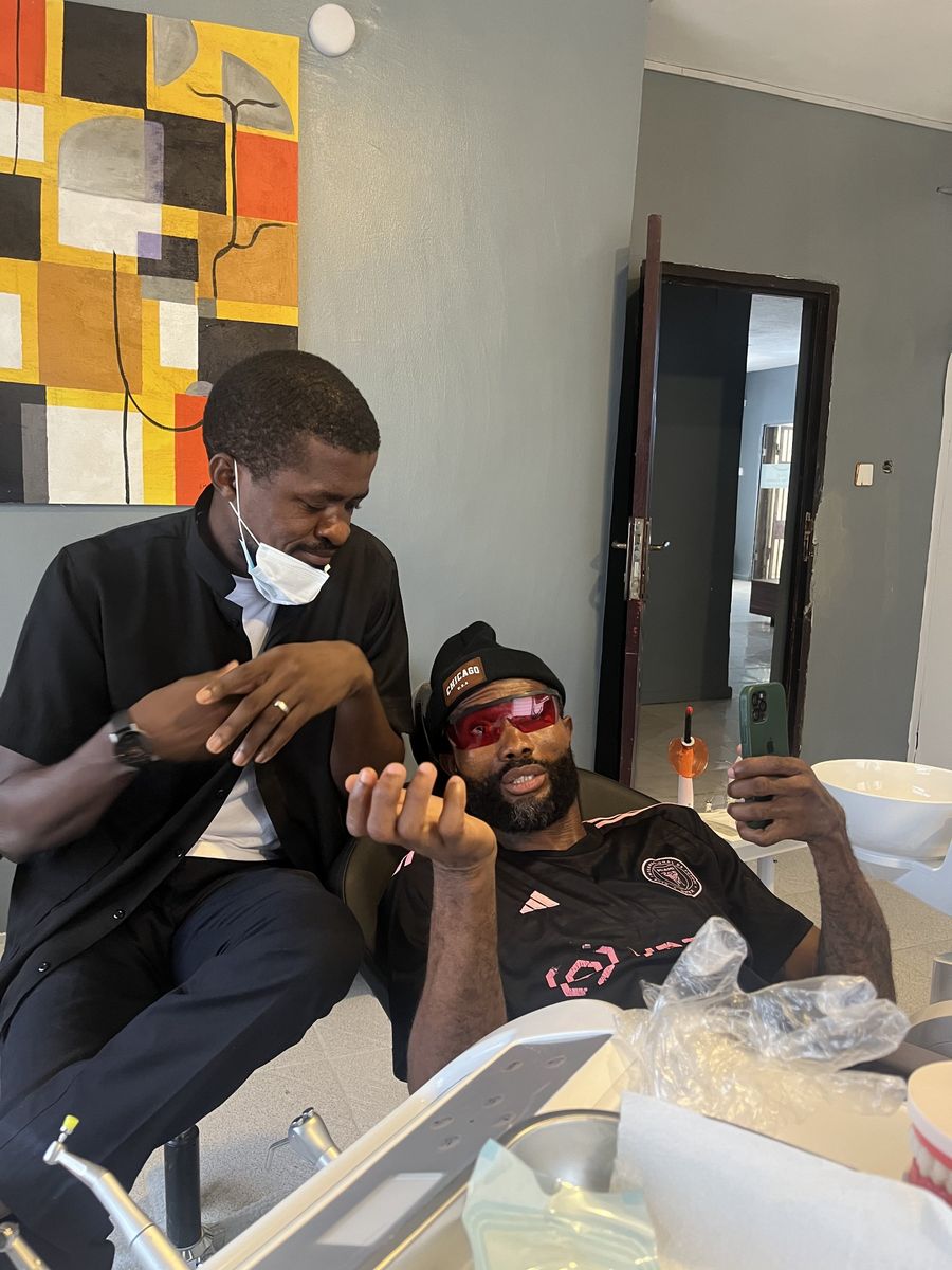 A dentist talking with a patient in the chair at Onaj Dental Clinic